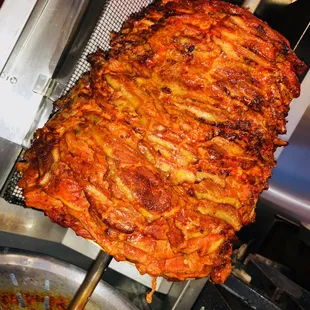 a large piece of meat being cooked