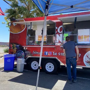 a man ordering food from a food truck