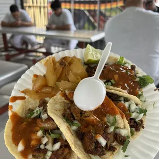 a plate of tacos and chips