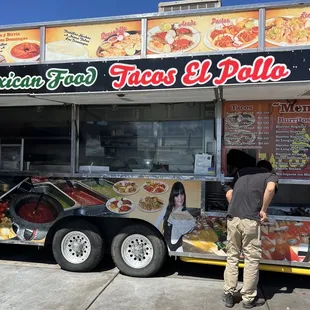 a man standing in front of a food truck