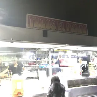 a woman standing in front of a food truck