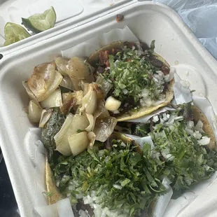 2 asada, 1 steak taco. Onions and peper included