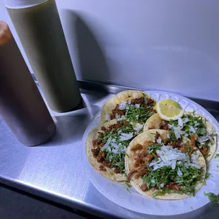 Tacos (al pastor and chorizo) with the red and green salsa