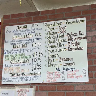 a menu on a brick wall