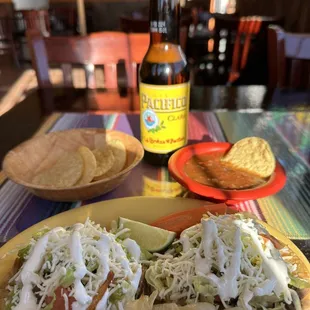 a bottle of beer and a plate of tortillas