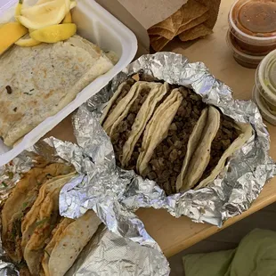 Five plain asada tacos, one regular asada taco, one regular al pastor taco, asada quesadilla, side of chips and salsa.