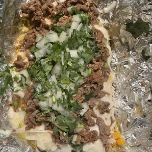 Papa con carne asada con todo - delicious! The corn is a unique added touch!