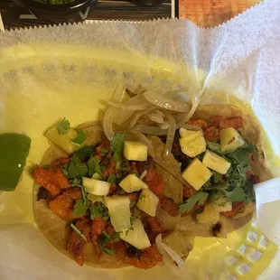 Tacos with pineapple and onion. Cilantro and lime added at our table.