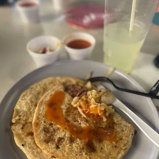 a plate of tacos and a drink