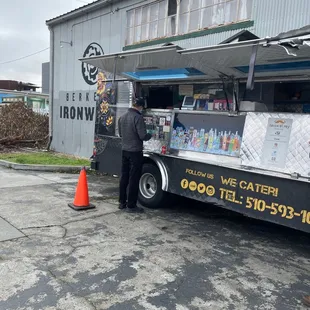 a man standing in front of a food truck