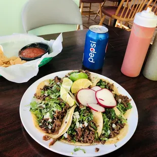 a plate of tacos and chips