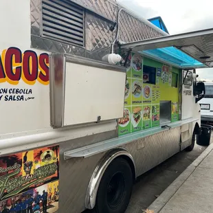 a taco truck parked on the side of the road