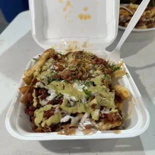 Half nachos/ half fries de pastor delicious