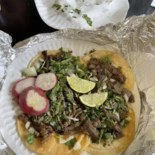 Two asada tacos on the left, two lengua tacos on the right.