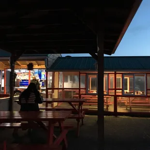 Taco truck with a little outdoor and indoor sitting area