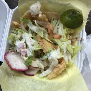 a close up of a taco in a styrofoam container