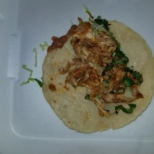 a chicken taco in a styrofoam container