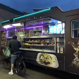 a man standing in front of a food truck