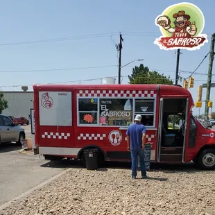 a man standing in front of a food truck