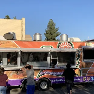 people ordering food from a food truck