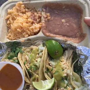 Chicken tacos, beans and rice.