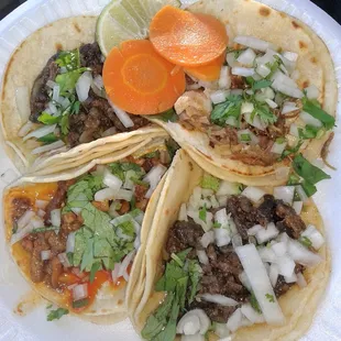 2 carne asada, carnitas and al pastor tacos, 3.5/5 (with added salsas)