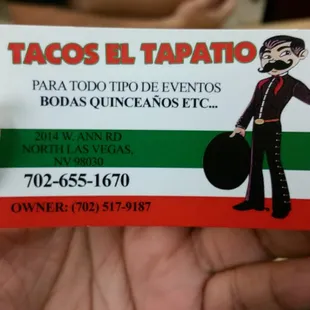 a hand holding a taco
