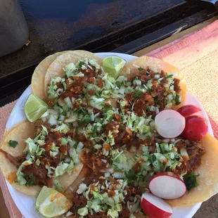 a plate of tacos and radishes