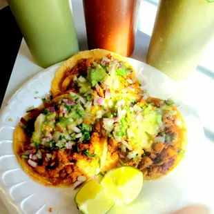 a plate of tacos and a drink