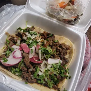 a taco with meat and vegetables