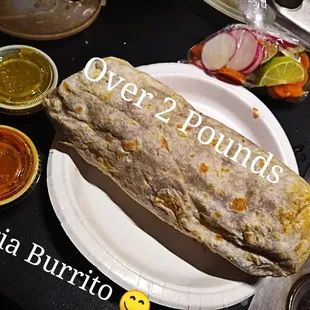 a burrito on a paper plate
