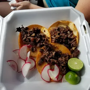 Asada tacos before getting cabbage, cilantro and onion and salsa added. Sooooo good.