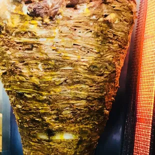 a large kebab on a yellow plate