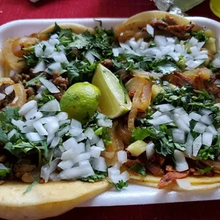 Left: asada meat//Right: trompo meat both with cilantro, grilled onion, and fresh chopped onion &amp; lime!