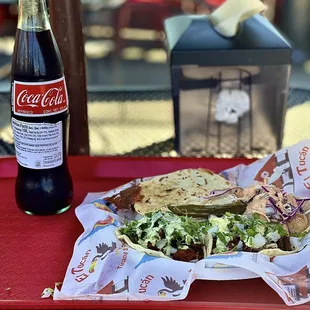 a tray of food and a bottle of coke