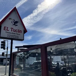 Sign and outdoor patio at Tacos El Tucán in Richmond.