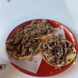 two tacos on a red plate