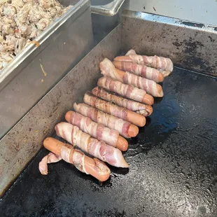 Yes, they do bacon-wrapped hot dogs! The kids loved them!