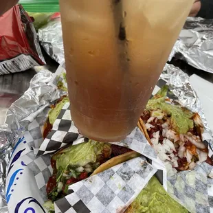 Adobada tacos packed with meat with a double long island from bar sin nombre