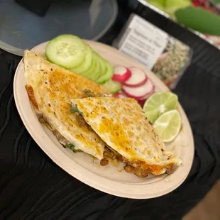 a plate of quesadillas and cucumbers
