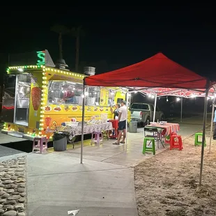 a taco truck with neon lights