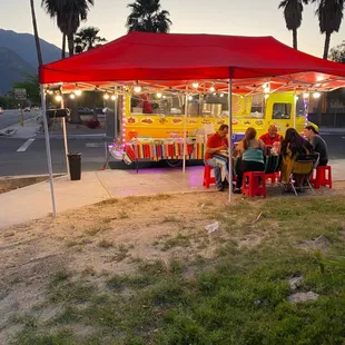 a taco truck parked under a tent