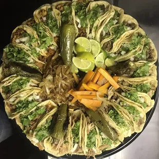 a platter of tacos and vegetables