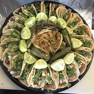 a platter of tacos and pickles