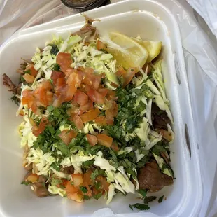 Carnitas Ensenada bowl with rice and beans.