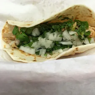 Dinner, a chicken taco with onion and cilantro on a flour tortilla, sort of healthy?