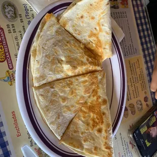 a plate of quesadillas and a cell phone