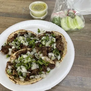 Carne Asada three tacos à la cart, cli tomatillo hot sauce and vegetables that come with it