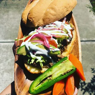 a hand holding a plate of food