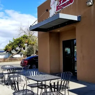 tables and chairs outside of a restaurant